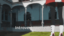 a person standing in front of a building with the words introvert spotted