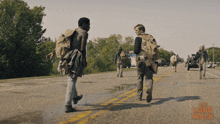 a group of people walking down a road with the long walk written on the bottom right