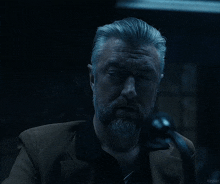 a man with gray hair and a beard says " excuse me "