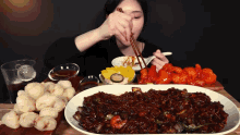 a woman is eating a large plate of food