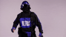 a man wearing a mask and headphones is wearing a black and blue shirt with the word zilla on it