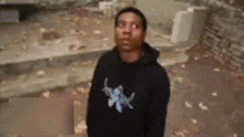 a man is wearing a black hoodie with a blue star on it