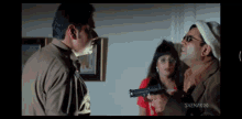 a man is pointing a gun at another man in a scene from a movie called snehaboo