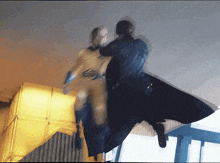 a blurry image of a man in a superhero costume fighting another man