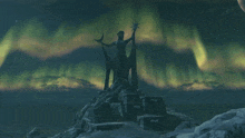 a statue of a woman with a star in her hand stands in front of the northern lights