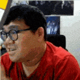 the man is wearing glasses and a red shirt