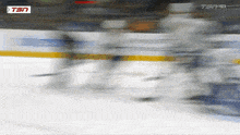 a blurry picture of a hockey game with tsn on the bottom right