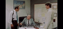 a man sitting at a desk with a caption that says " you 're the officer in charge of the case "