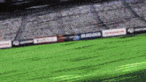 a blurry picture of a soccer field with a blue lock sign in the background .
