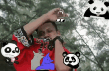 a man in a red shirt is surrounded by pandas and cats