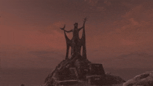 a statue of a woman standing on top of a rocky hill