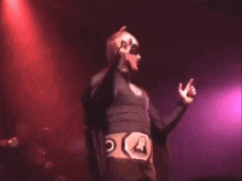 a man wearing a mask and a black shirt with the letter a on it
