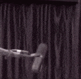 a drawing of a woman with a microphone in front of a curtain