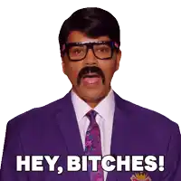 a man in a purple suit and tie is saying hey bitches