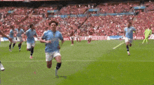 a soccer player wearing a shirt that says etihad on it