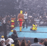 a wrestling ring with a referee and a wrestler wearing a hulk hogan outfit