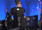 a man wearing a black shirt with the word noz on it