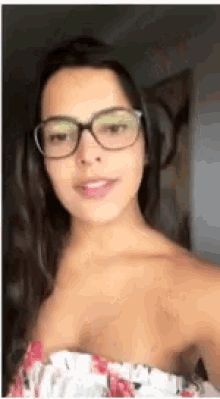 the woman is wearing glasses and a floral top