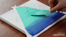 a person is painting a blue and green gradient on a canvas made in animatica