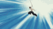 a man is jumping in the air with a sword .