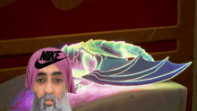 a man with a beard wearing a nike hat