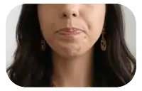 a close up of a woman 's face with her mouth open and earrings