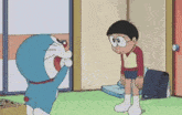 doraemon and nobita are standing next to each other in a room and looking at each other .