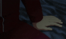 a close up of a person 's hand on a blue surface