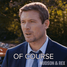 a man in a suit and tie says of course