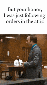 a man in a suit is giving a speech in a courtroom and says but your honor i was just following orders