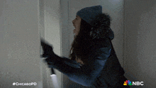 a woman is holding a flashlight and screaming in a chicagopd ad