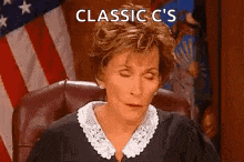 a judge is sitting in a courtroom with her eyes closed and the words `` classic c 's '' above her .