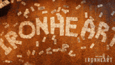 the word ironheart is made out of money on a wooden surface