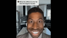 a man in a suit and tie is smiling in a kitchen while wearing ear buds ..