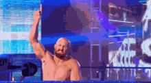 a man in a wrestling ring with a w logo on the bottom