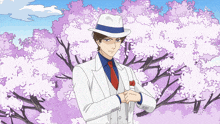 a man in a white suit and hat is standing in front of a tree