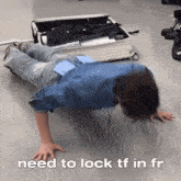 a man is doing push ups in front of a suitcase that says " need to lock tf in fr "