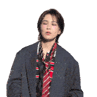 a woman in a suit and tie is making a gesture