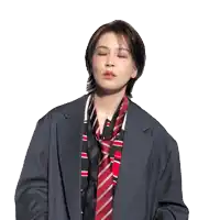 a woman in a suit and tie is making a gesture