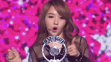 a woman holding a microphone that says ladies code on it