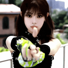 a girl with chinese writing on her arm is giving a thumbs up sign
