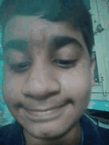 a close up of a person 's face with their eyes closed and a smile on their face .