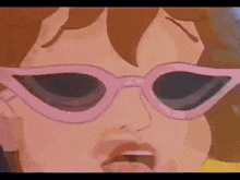 a close up of a cartoon character wearing pink sunglasses and making a funny face .