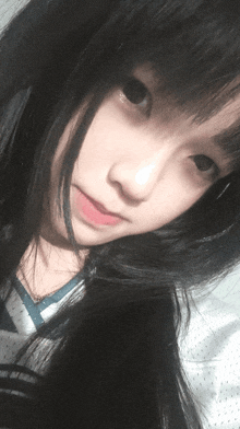a close up of a girl 's face with black hair