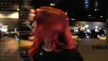 a woman with red hair stands in front of a blurred background that says 111815