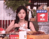 a woman is sitting at a table with a sign that says 5