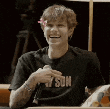 a man wearing a black shirt that says stay sun on it