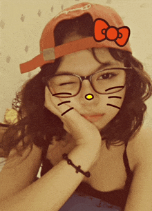 a girl wearing glasses and a red hat with a red bow on it