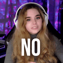 a woman wearing headphones with the word no written on her face