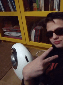 a man wearing sunglasses giving a peace sign